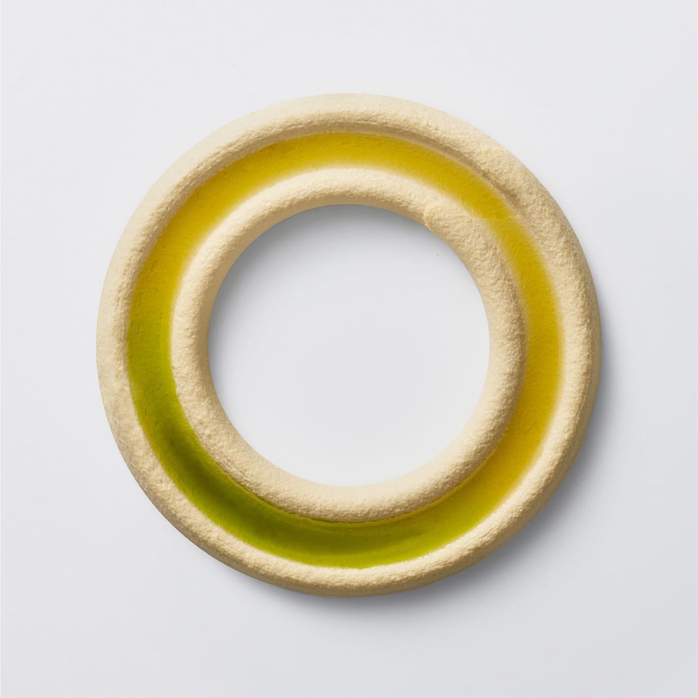 Creative plated hummus and oil in a circle.