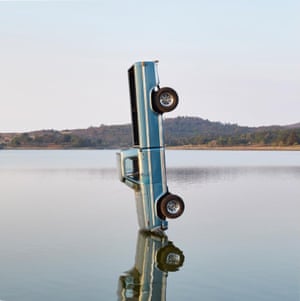 Cover image by Gonzalo Lebrija for F-1 Trillion by Post MalonePost Malone’s F-1Trillion album cover visuals were created by Gonzalo Lebrija, a renowned modern artist on Mexico’s multi-media scene. To capture the shot, Lebrija and his team used a crane to drop the truck into Presa Salto del Nogal in Jalisco, Mexico The image draws inspiration from previous pieces in Lebrija’s catalogue, particularly As Time Goes By, which featured a car suspended on a lake in much the same way.